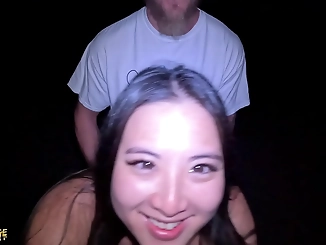 Witness a luscious enchantress fulfilling her desires on the beach at night with public pussy-eating and blowjob action!